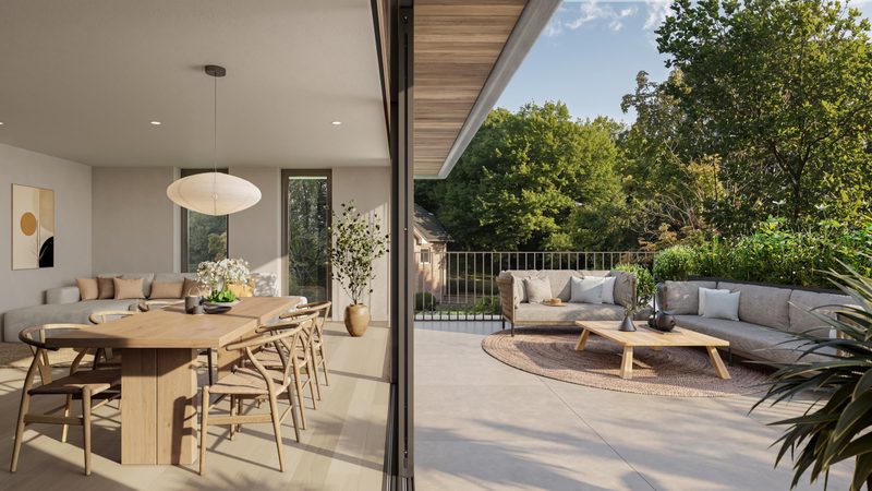 Overdekt terras met eettafel en loungezetel, met zicht op het groen